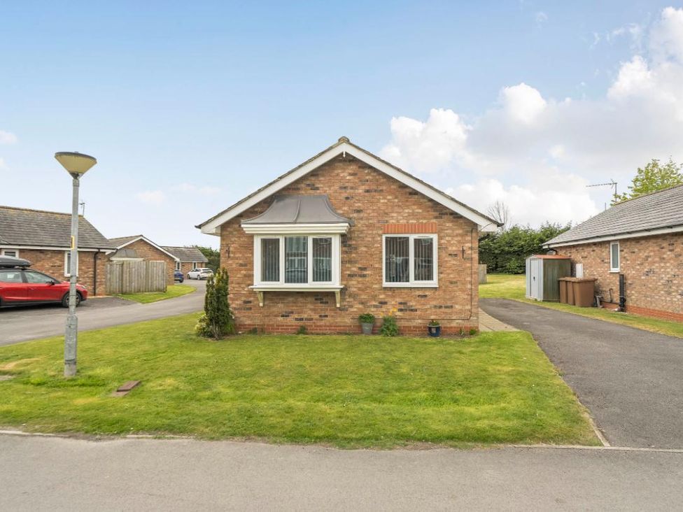 A bungalow with a front garden and driveway at Ivy Corner in Bridlington