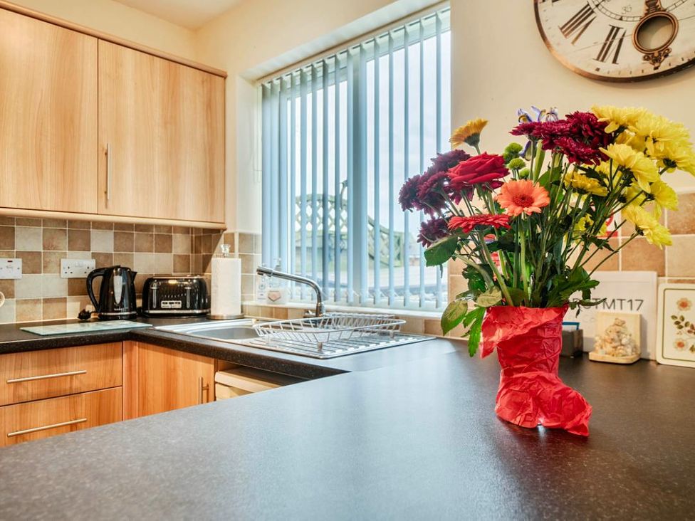 A kitchen with cabinets and appliances at Ivy Corner in Bridlington