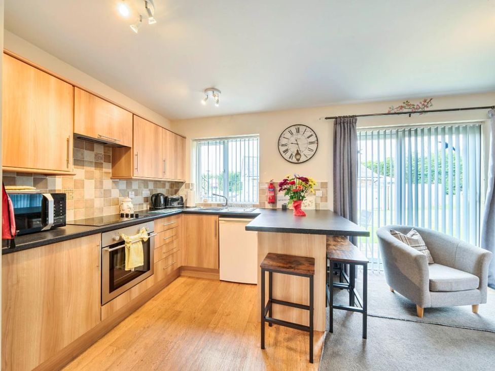 A kitchen with cabinets and appliances at Ivy Corner in Bridlington