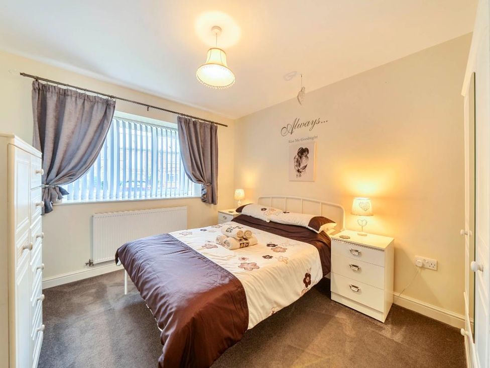 A bedroom with a bed and a dresser at Ivy Corner in Bridlington