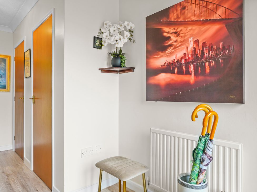 A hallway with doors and a painting at The Old Barn in Manchester