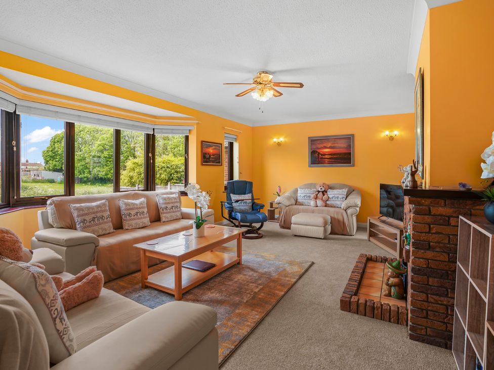 A living room with furniture and a fireplace at the property in unspecified location