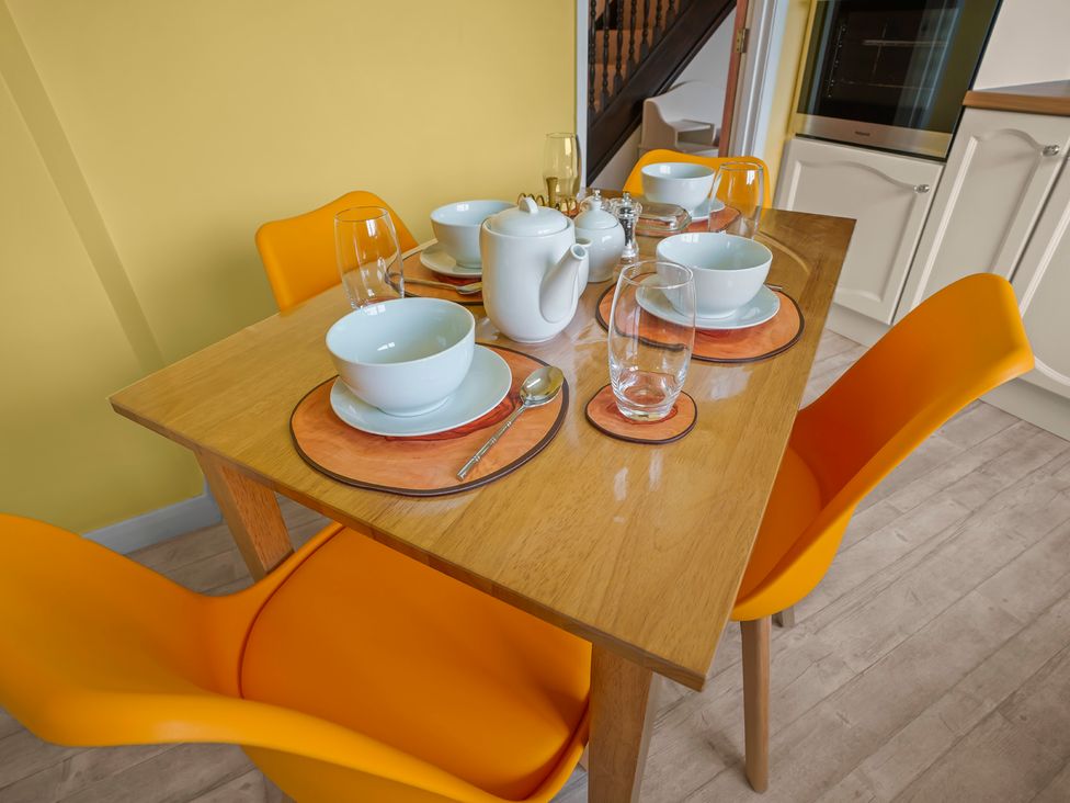 A dining room table set with bowls and glassware at The Old Barn in Manchester