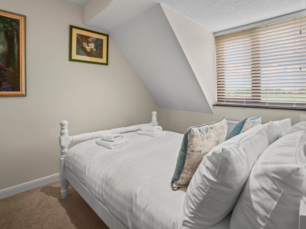 A bedroom with a bed and decorative pillows at The Old Barn in Manchester