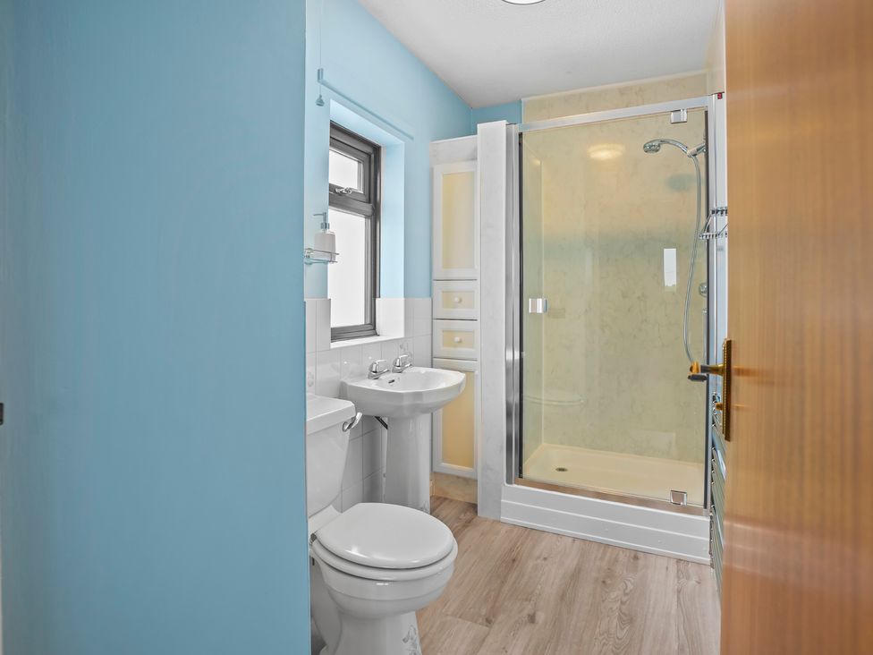 A bathroom with a toilet, sink, and shower at The Old Barn in Manchester