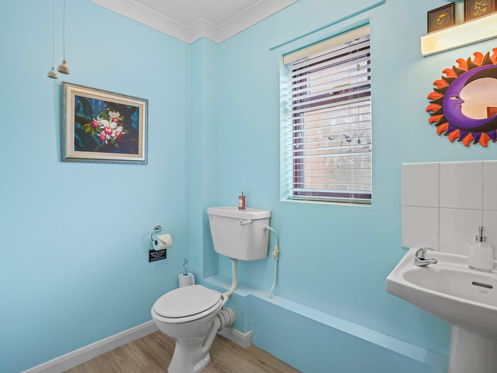 A bathroom with toilet and sink at the property