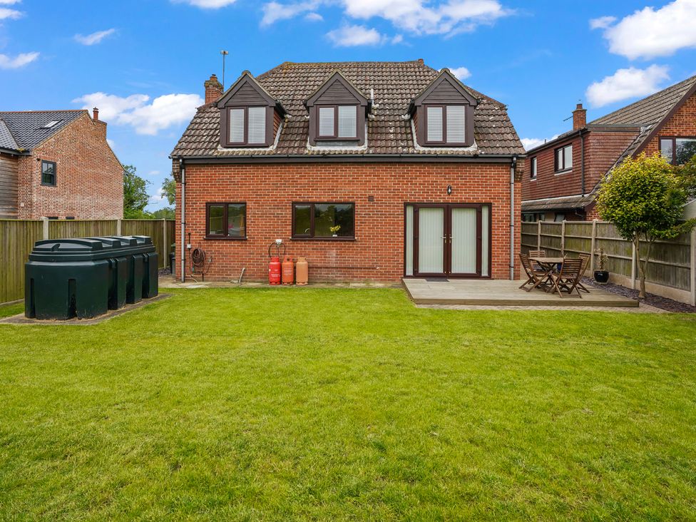 A house with a garden and decking at the outdoor area