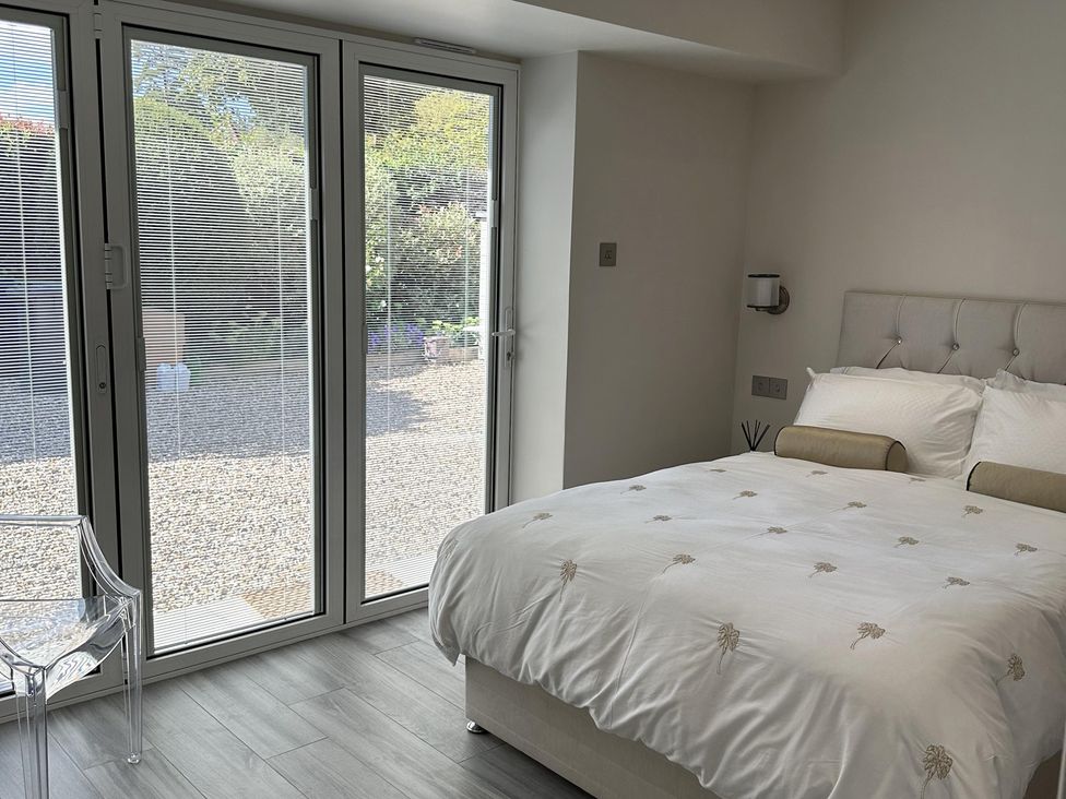 A bedroom with a bed and a chair at Quay house studio