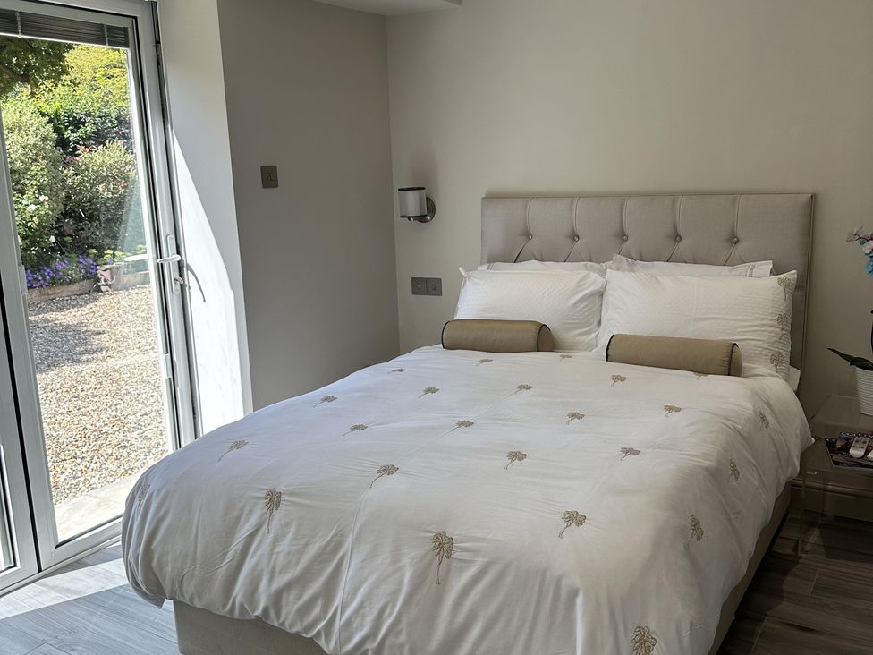 A bedroom with a bed and sliding door at Quay house studio 