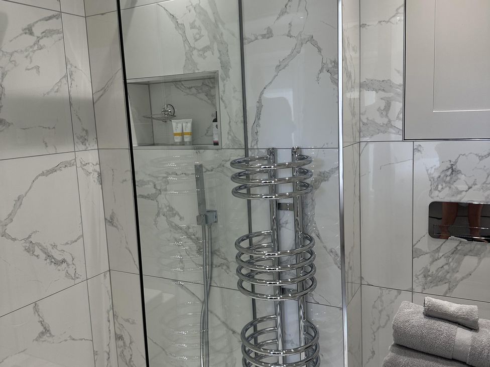 A bathroom with a shower and towels at Quay house studio