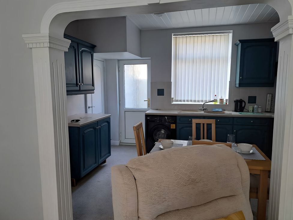 A kitchen with a table and chairs at Fisherman's Cottage in 