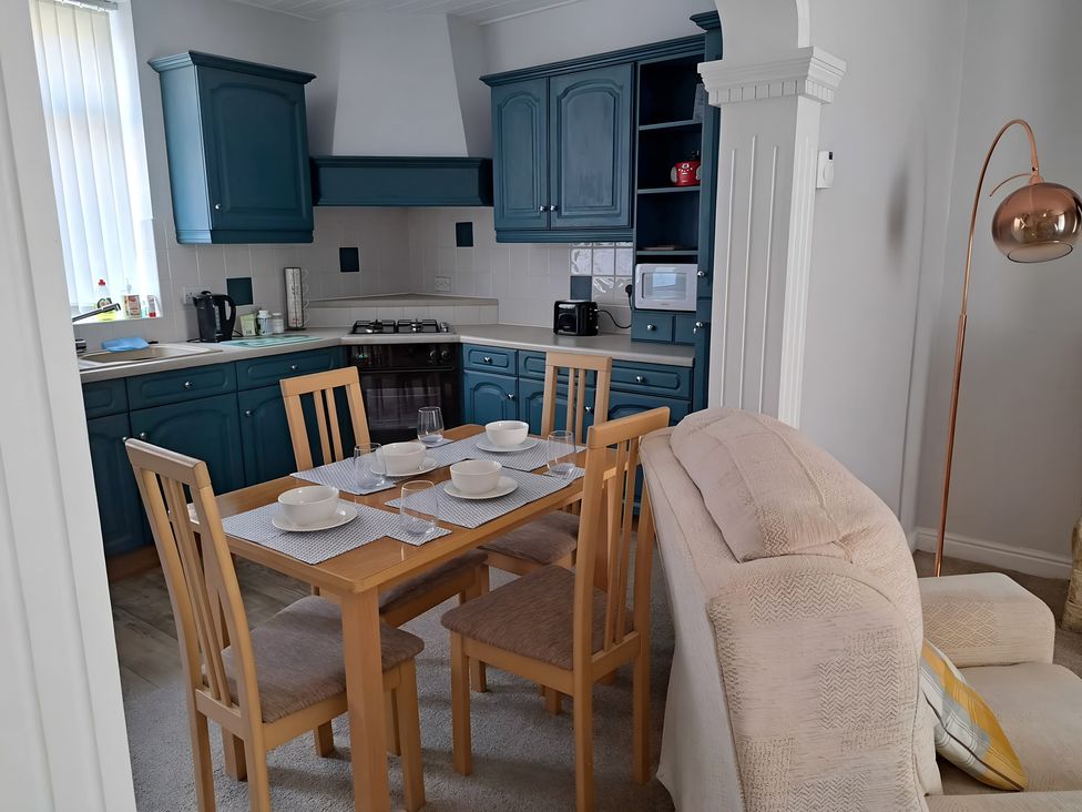 A kitchen with a dining table and chairs at Fisherman's Cottage