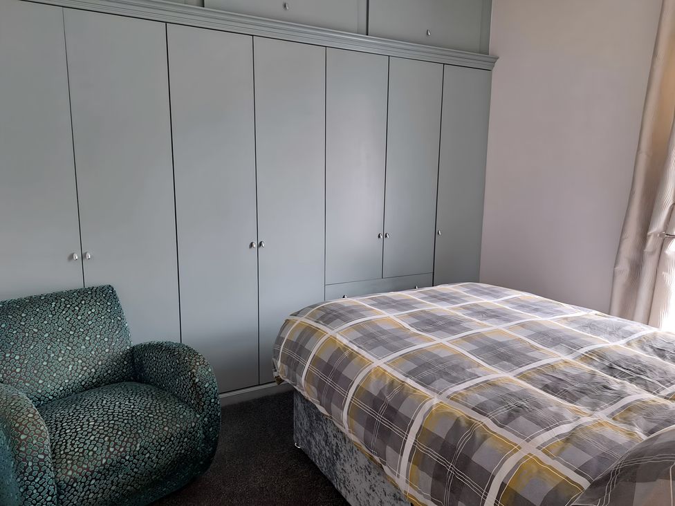 A bedroom with a bed and wardrobe at Fisherman's Cottage in 