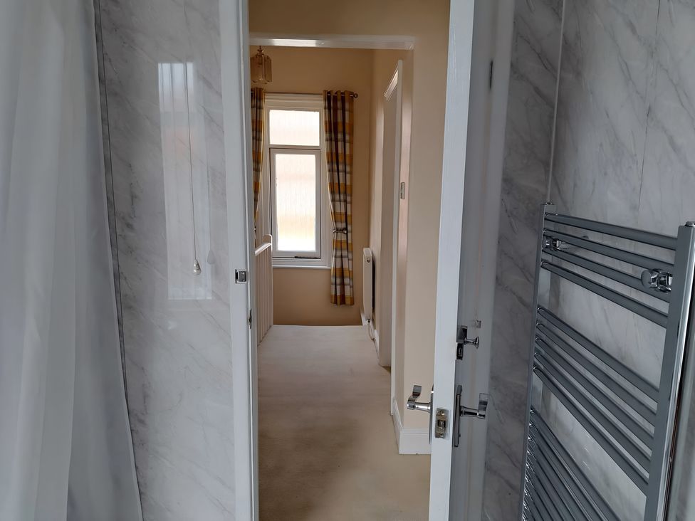 A bathroom with a shower and window at Fisherman's Cottage