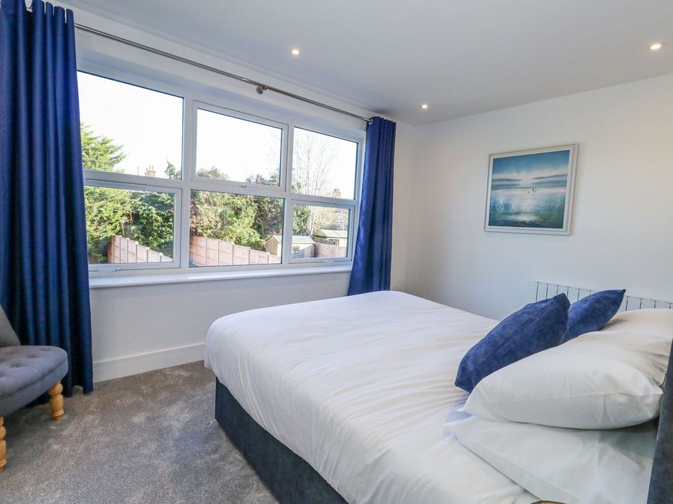 A bedroom with a bed and window at Sea Fern House - 36 in Poole
