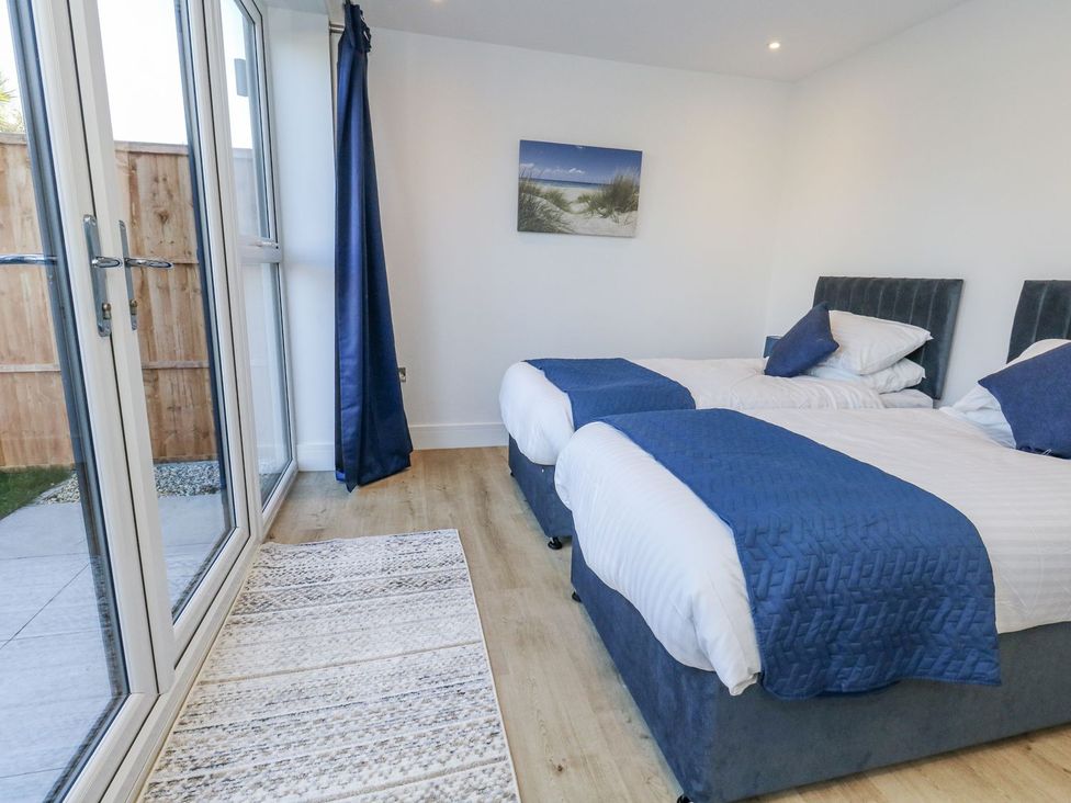 A bedroom with two beds and a window at Sea Fern House - 36 in Poole