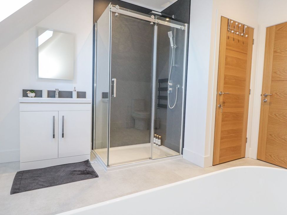 A bathroom featuring a shower and sink at Sea Fern House - 36 Poole