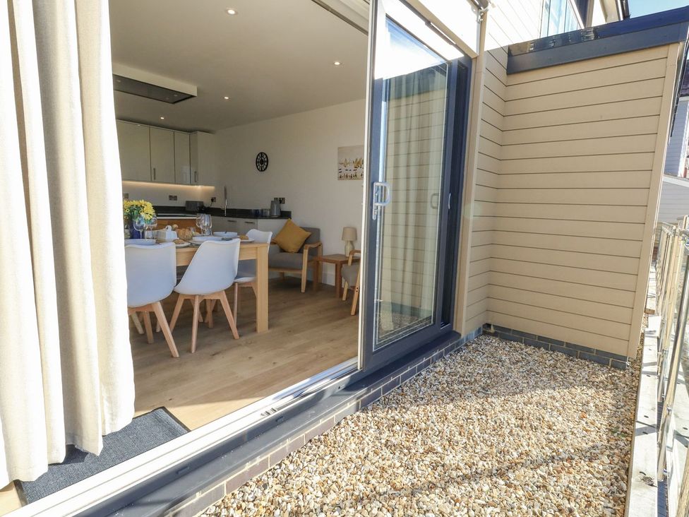 Dining area with table and chairs at Sea Fern House - 36 in Poole