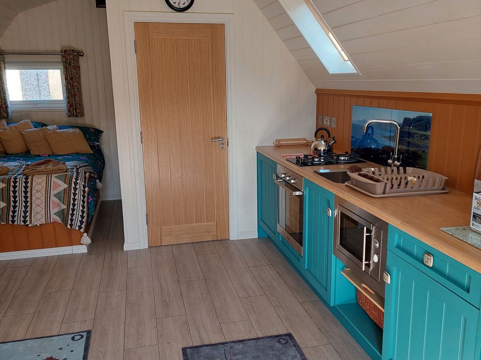 A kitchen with a bed and door at a rental property in an unspecified location