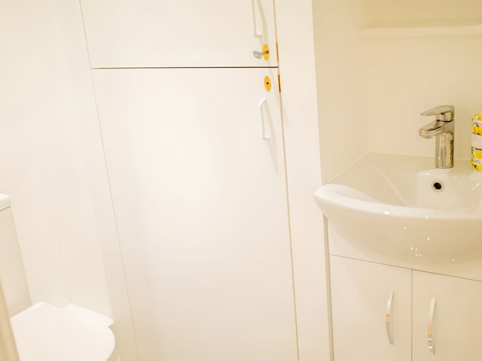 A bathroom with a toilet and sink at Red Rose Apartment