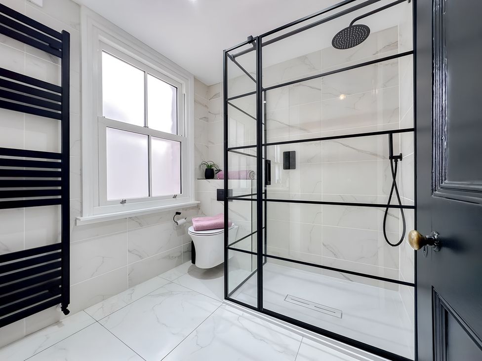 A bathroom with a shower and toilet at Victorian Beach House 