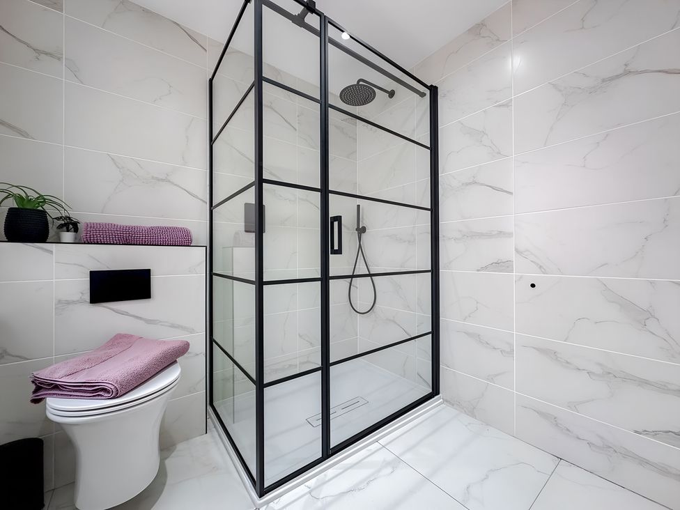A bathroom with a shower and toilet at Victorian Beach House
