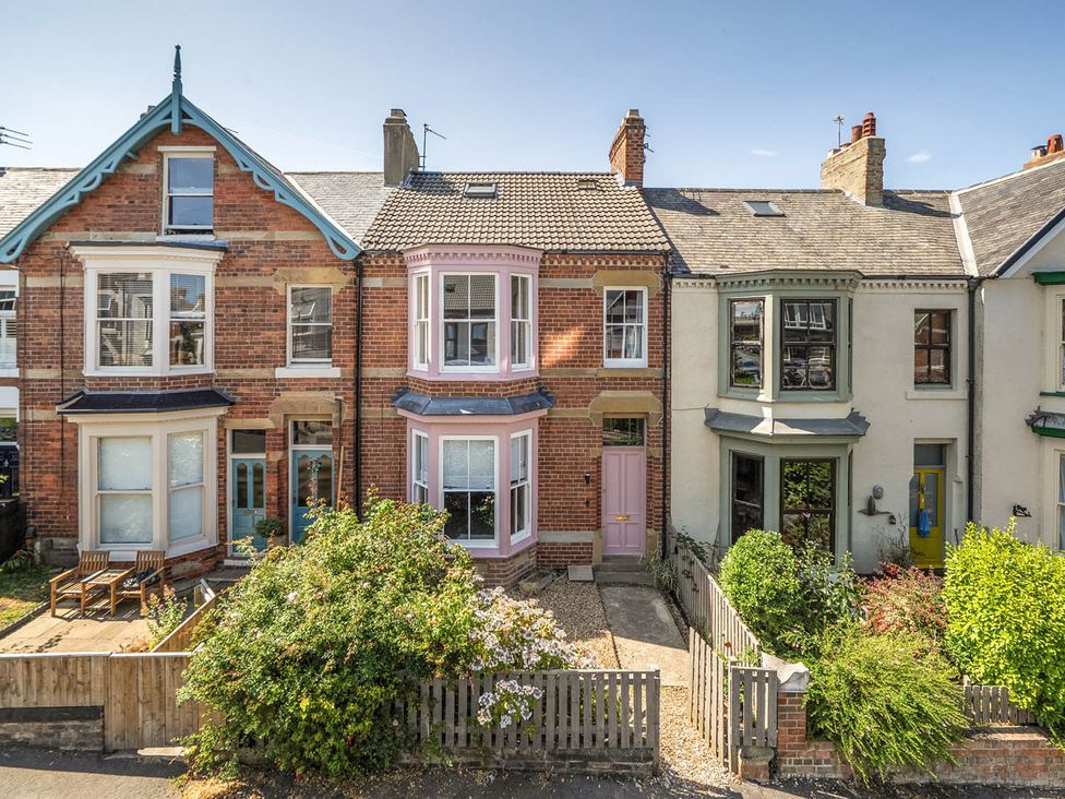 A row of houses with front gardens at Victorian Beach House in Saltburn-By-The-Sea