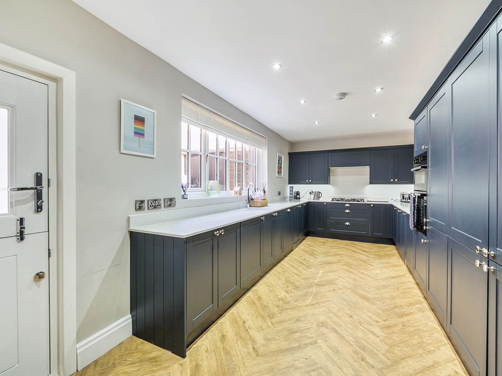 A kitchen with cabinets and appliances at Victorian Beach House in Saltburn-By-The-Sea
