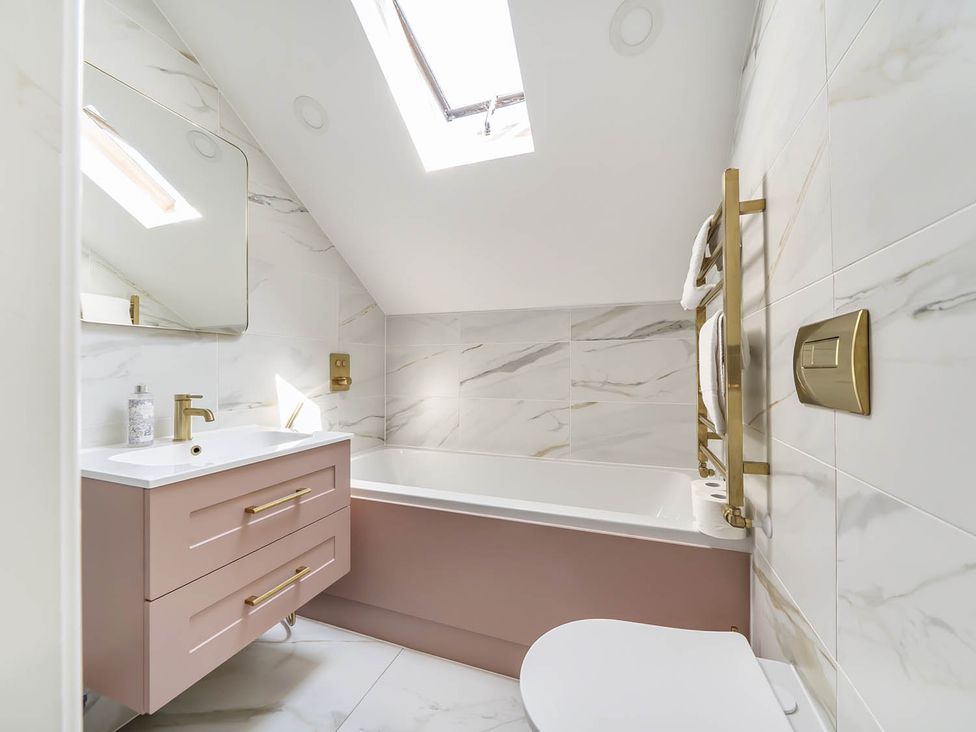A bathroom with a bathtub and sink at Victorian Beach House in Saltburn-By-The-Sea