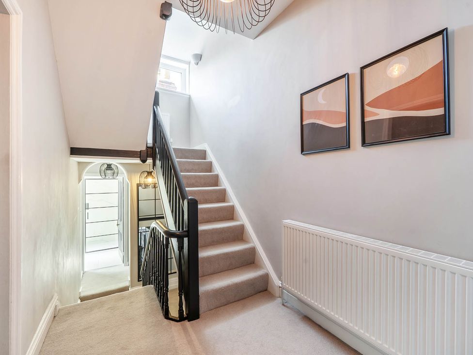 A hallway with stairs leading up at Victorian Beach House Saltburn-By-The-Sea