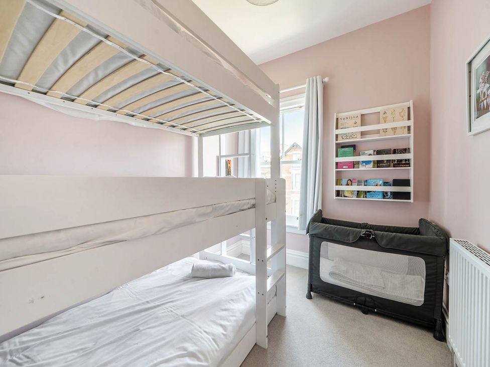 A bedroom with a bunk bed and crib at Victorian Beach House in Saltburn-By-The-Sea