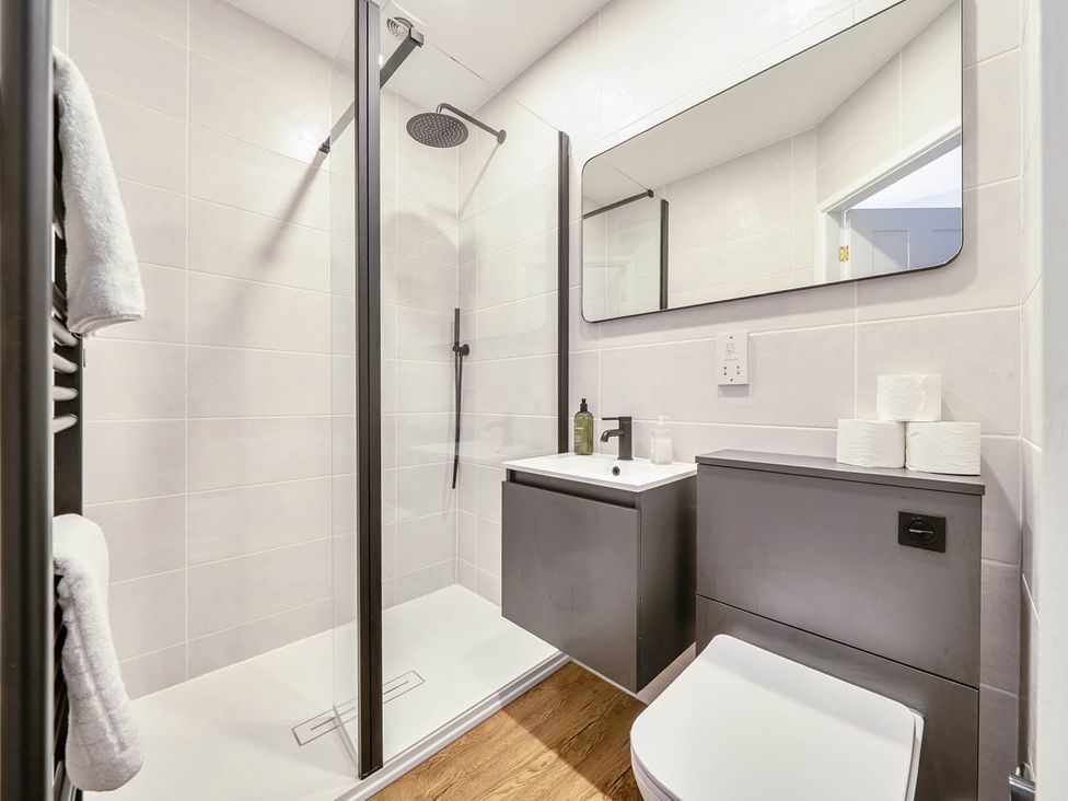 A bathroom with a shower, sink, and toilet at Victorian Beach House in Saltburn-By-The-Sea