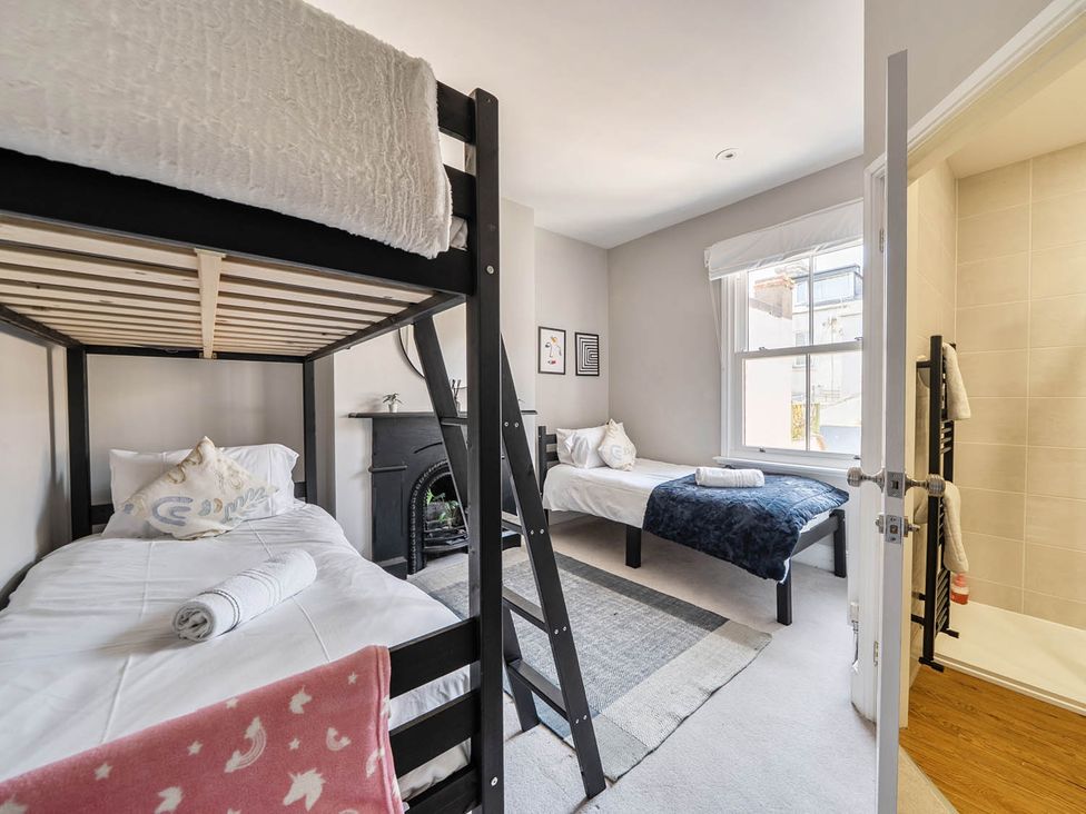 A bedroom with bunk bed and single bed at Victorian Beach House in Saltburn-By-The-Sea