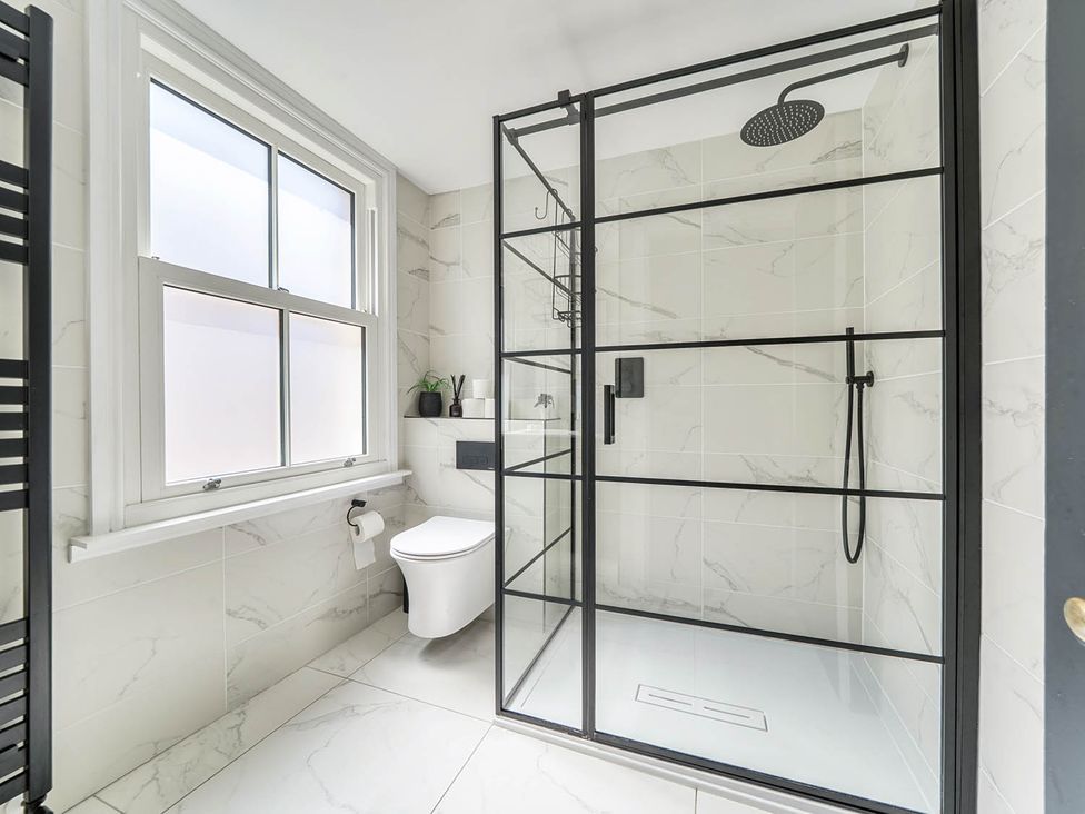 A bathroom with a shower, toilet, and sink at Victorian Beach House in Saltburn-By-The-Sea
