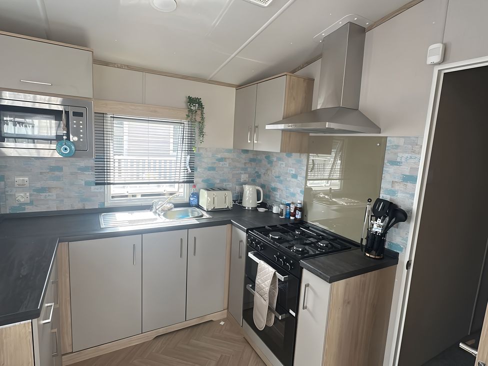 A kitchen with appliances and a sink at Pine 48