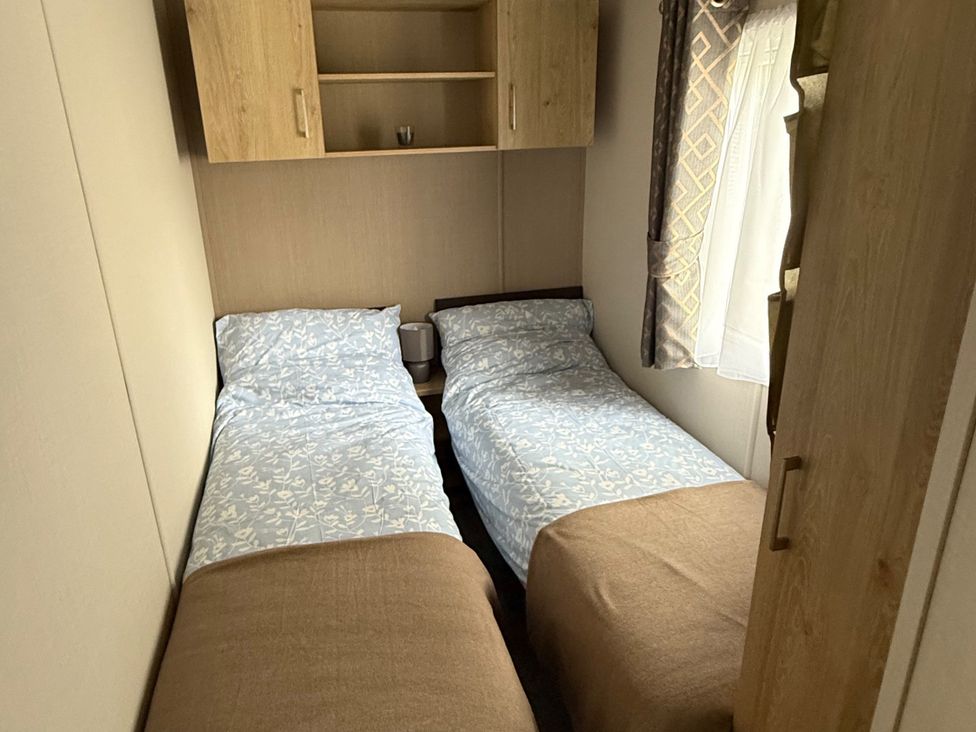 A bedroom with two beds and a shelf at Pine 48