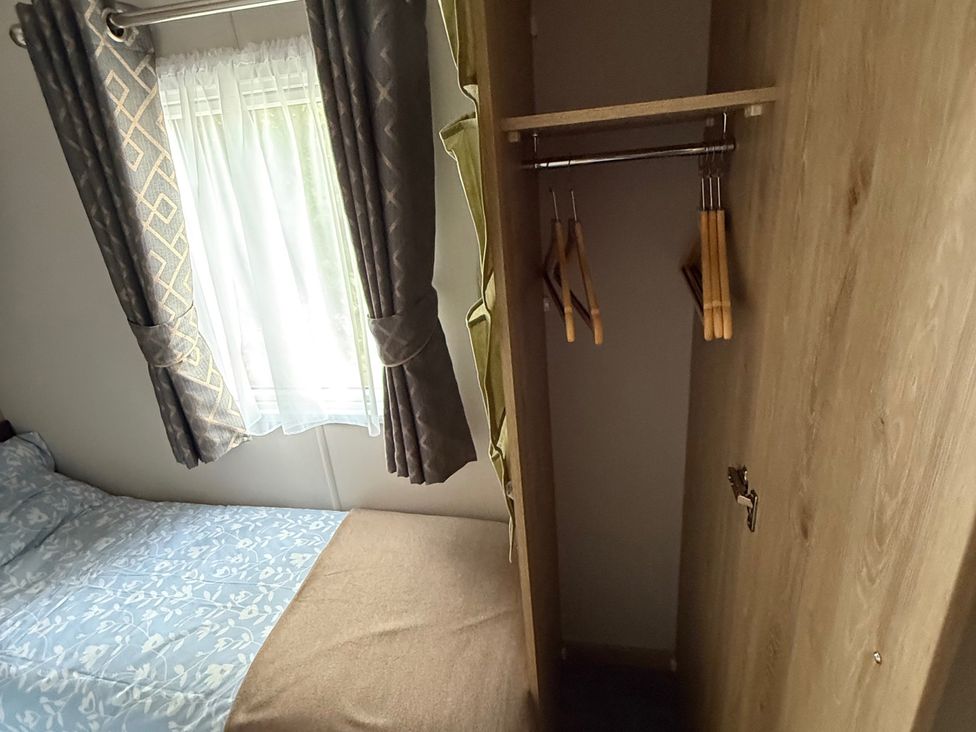 A bedroom with a bed and wardrobe at Pine 48