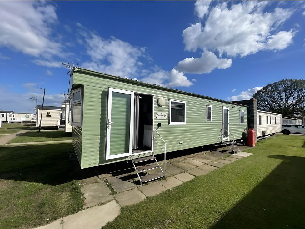A mobile home with a green exterior and steps at 214 Oaklands Area