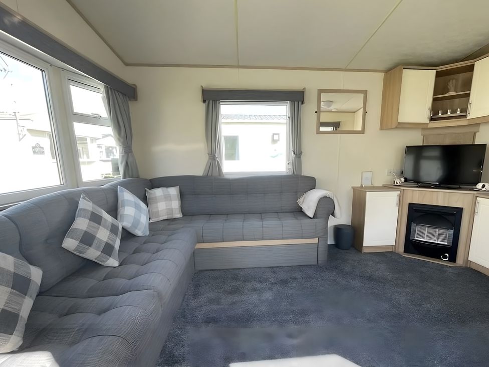 A living room with a sofa and television at 214 Oaklands Area
