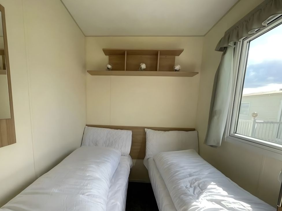 A bedroom with two beds and a shelf at 214 Oaklands Area