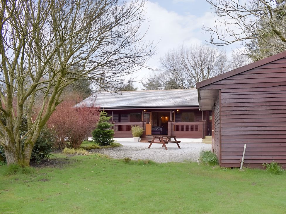 A cabin with outdoor furniture and garden at Gisburn Forest Lodge