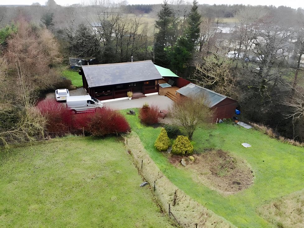 A building with a green roof and a van in the garden at Gisburn Forest Lodge