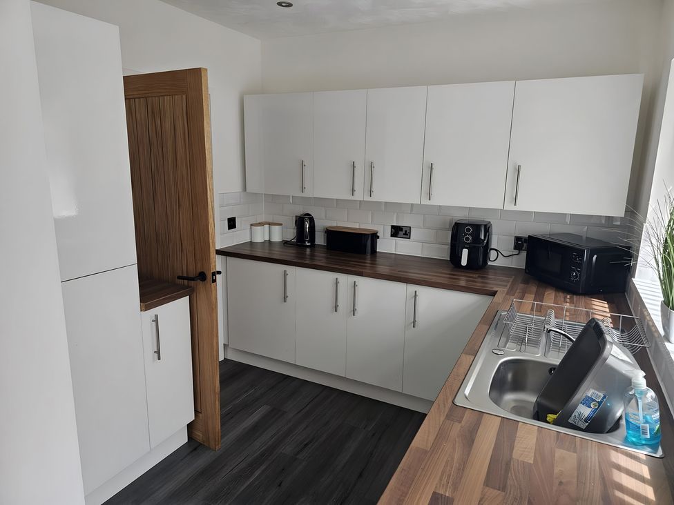 A kitchen with cabinets and appliances at 58 Clifton Rise