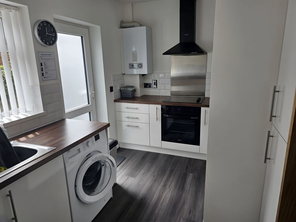 A kitchen with a washing machine and oven at 58 Clifton Rise 