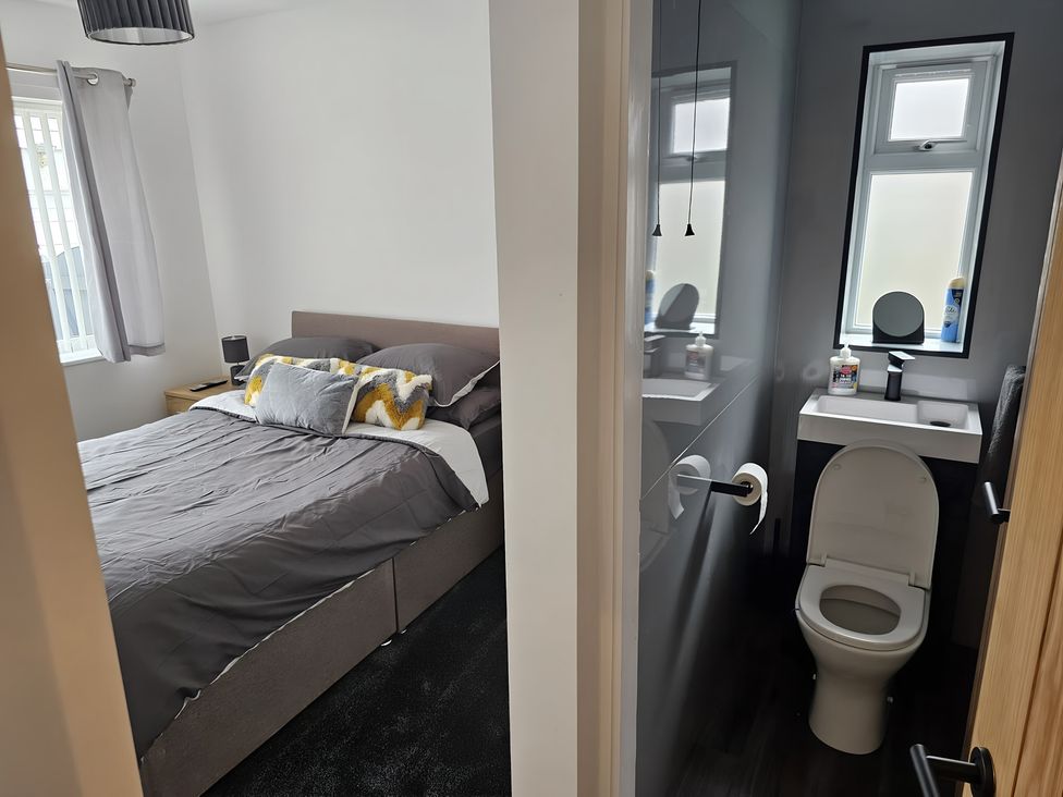A bedroom with a bed and an adjoining bathroom at 58 Clifton Rise