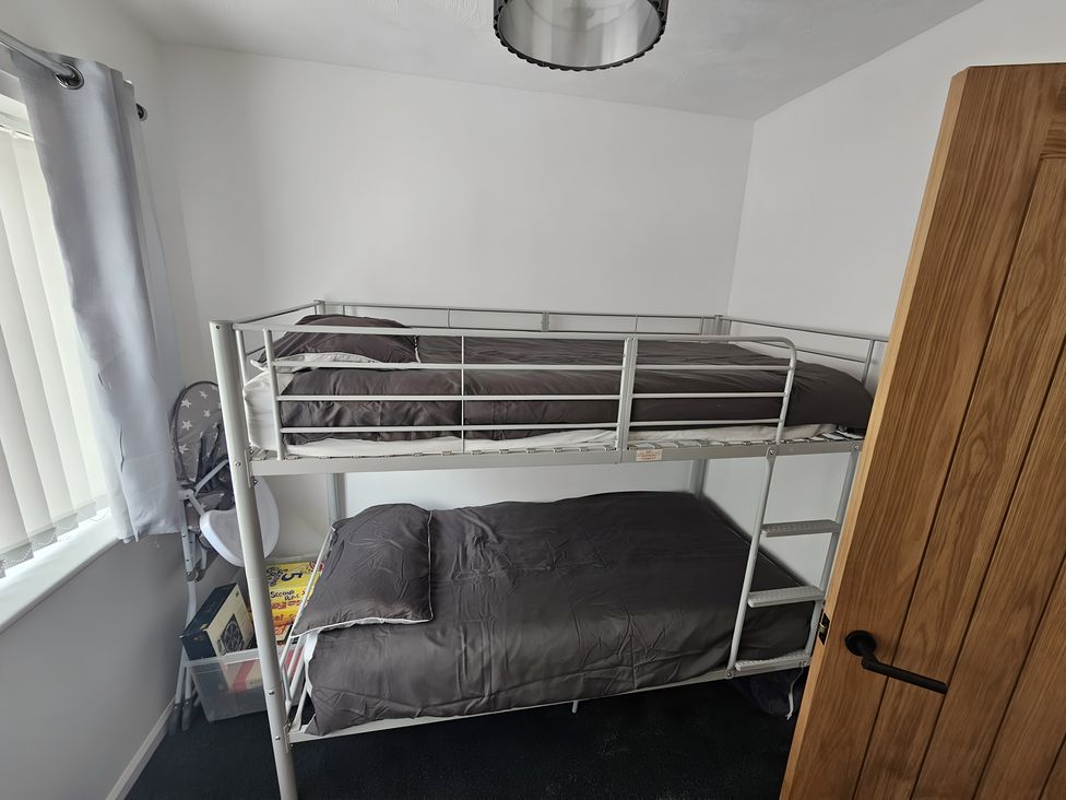 A bedroom with a bunk bed and a window at 58 Clifton Rise