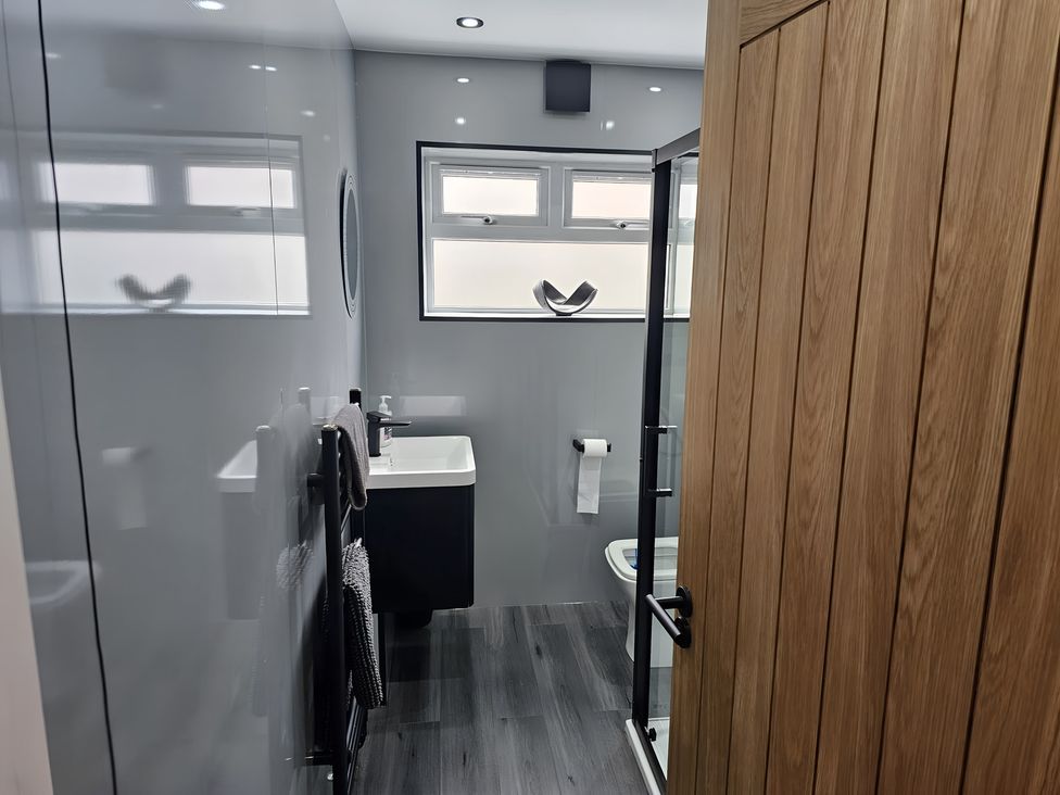 A bathroom with a shower, toilet and sink at 58 Clifton Rise