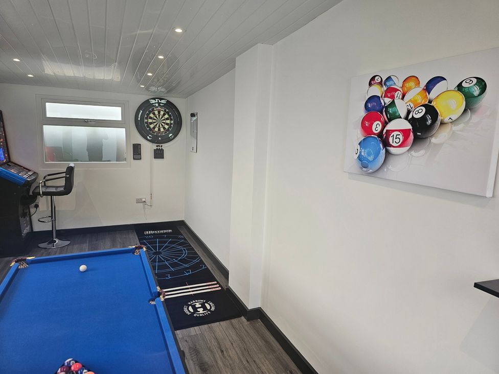 A snug with a pool table and dartboard at 58 Clifton Rise