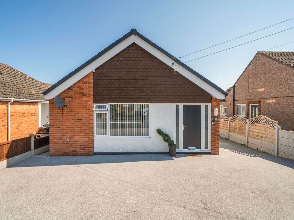 A house with a driveway and plant at 58 Clifton Rise in Abergele