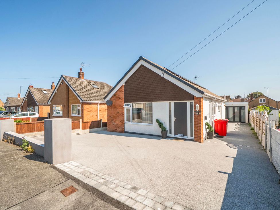 A house with a driveway and garden features at 58 Clifton Rise Abergele